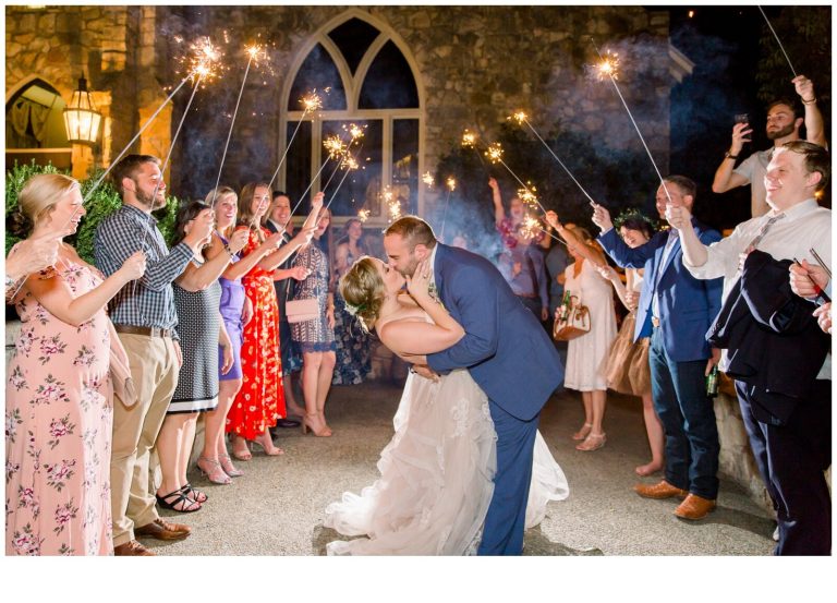 Couple kissing while surrounded by friends in Beautiful Historic Hill Country Wedding Venue